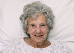 old woman lying on a hospital bed